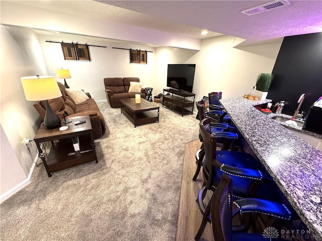 living room featuring baseboards, recessed lighting, visible vents, and carpet