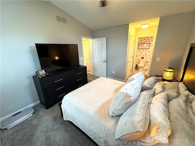 bedroom with lofted ceiling, baseboards, ensuite bath, dark colored carpet, and visible vents