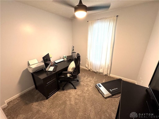 home office with ceiling fan, baseboards, and dark carpet