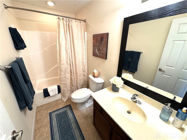 bathroom featuring tile patterned floors, toilet, vanity, and shower / bath combo with shower curtain
