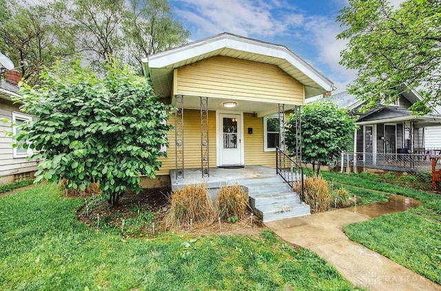 bungalow featuring a front yard and a porch