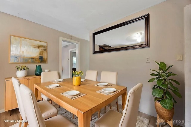 dining room featuring baseboards and wood finished floors
