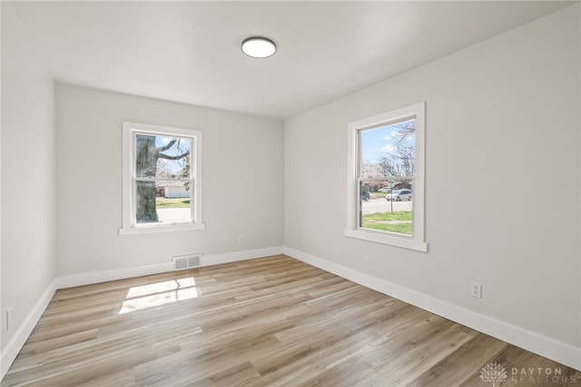 709 E Dorothy Ln, Dayton, OH 45419 - spare room featuring light wood finished floors, baseboards, and visible vents