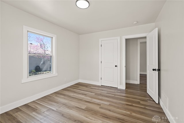 709 E Dorothy Ln, Dayton, OH 45419 - unfurnished bedroom featuring wood finished floors and baseboards