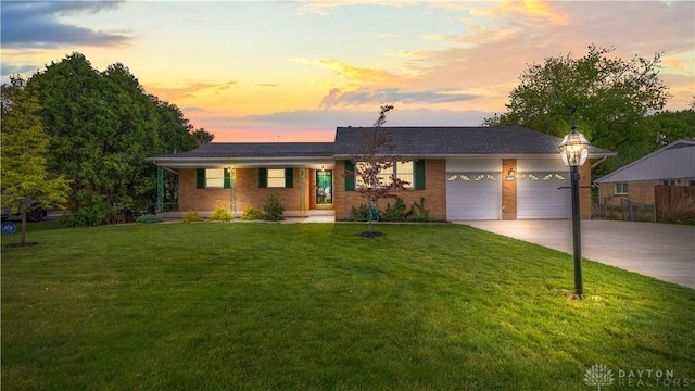 5149 Marshall Rd, Washington Twp, OH 45429 - ranch-style house with an attached garage, driveway, a yard, and brick siding
