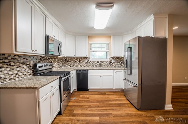 5149 Marshall Rd, Washington Twp, OH 45429 - kitchen with stainless steel appliances, a sink, light wood-type flooring, and white cabinets