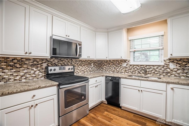 5149 Marshall Rd, Washington Twp, OH 45429 - kitchen featuring appliances with stainless steel finishes, a sink, white cabinetry, and decorative backsplash