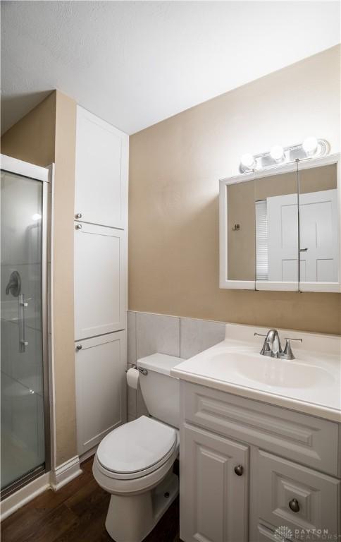 5149 Marshall Rd, Washington Twp, OH 45429 - full bath with vanity, a shower stall, wood finished floors, and toilet