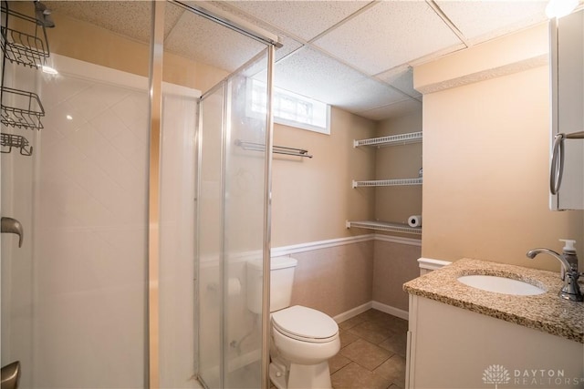 5149 Marshall Rd, Washington Twp, OH 45429 - full bathroom featuring a shower stall, vanity, toilet, tile patterned flooring, and a paneled ceiling