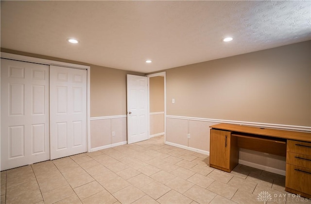 5149 Marshall Rd, Washington Twp, OH 45429 - unfurnished bedroom featuring recessed lighting, wainscoting, a desk, a closet, and light tile patterned flooring