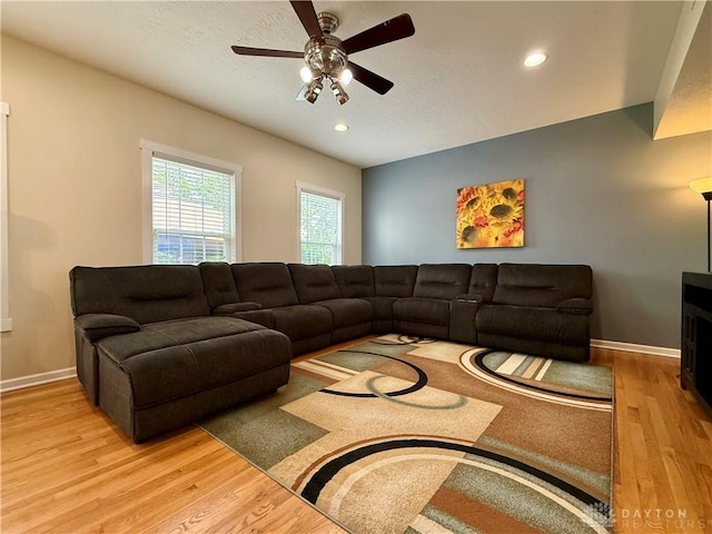 living room featuring wood finished floors, baseboards, ceiling fan, and recessed lighting