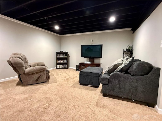 carpeted living room featuring ornamental molding and baseboards
