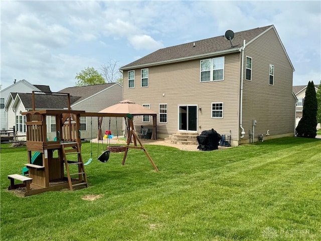 back of house with a lawn, entry steps, a gazebo, and a playground
