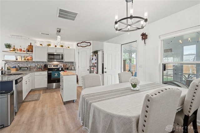 784 Marshall Dr, Xenia, OH 45385 - dining area with a chandelier and light wood-style floors