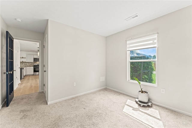 784 Marshall Dr, Xenia, OH 45385 - spare room featuring light colored carpet and baseboards