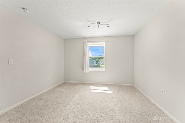 784 Marshall Dr, Xenia, OH 45385 - carpeted empty room with a smoke detector and a textured ceiling