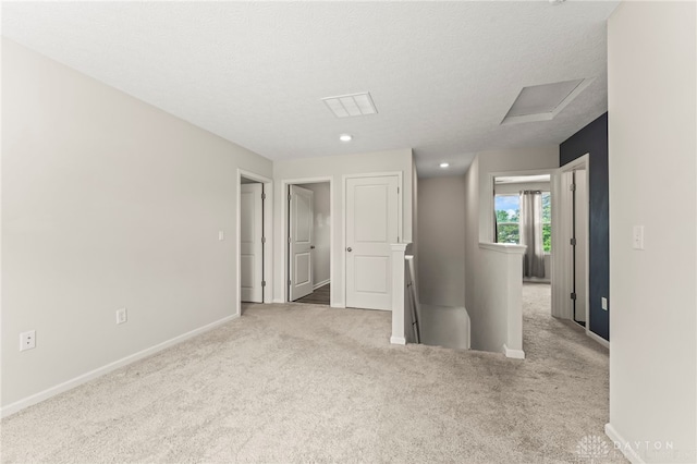 784 Marshall Dr, Xenia, OH 45385 - carpeted empty room with attic access and a textured ceiling