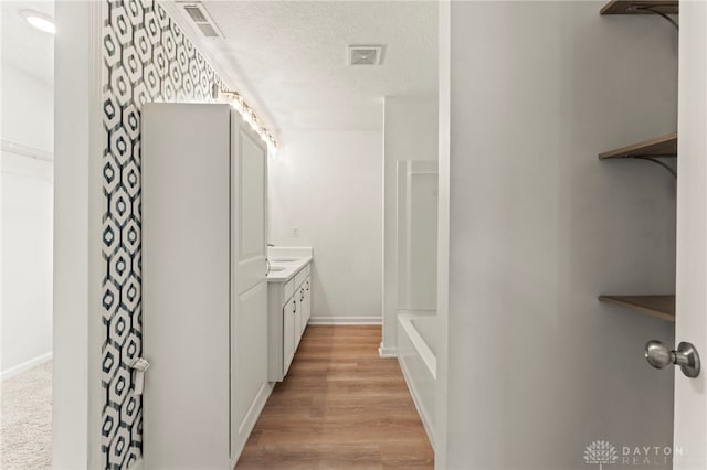 784 Marshall Dr, Xenia, OH 45385 - full bath with vanity, a textured ceiling, wood finished floors, and shower / washtub combination