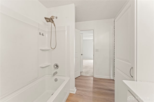 784 Marshall Dr, Xenia, OH 45385 - full bath featuring wood finished floors, shower / bath combination, and a textured ceiling