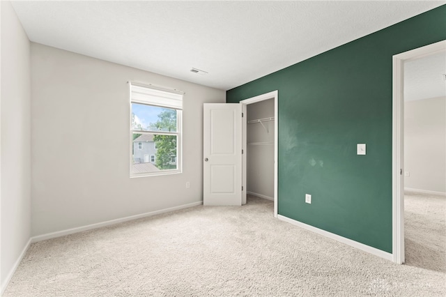 784 Marshall Dr, Xenia, OH 45385 - unfurnished bedroom featuring carpet flooring, a closet, and a spacious closet