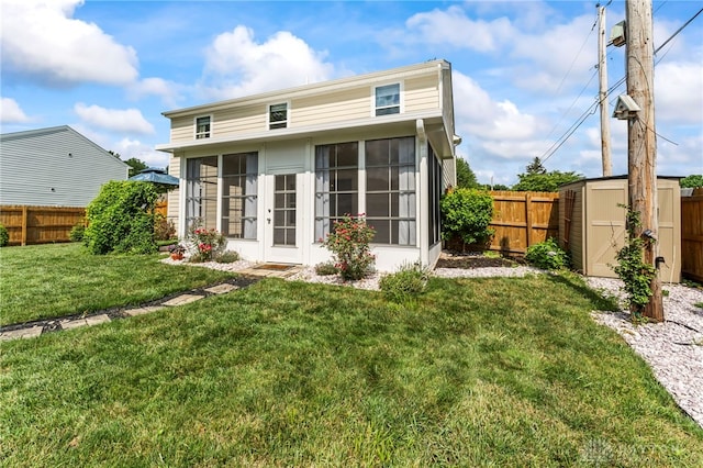 784 Marshall Dr, Xenia, OH 45385 - rear view of house featuring a sunroom, a fenced backyard, and a storage unit