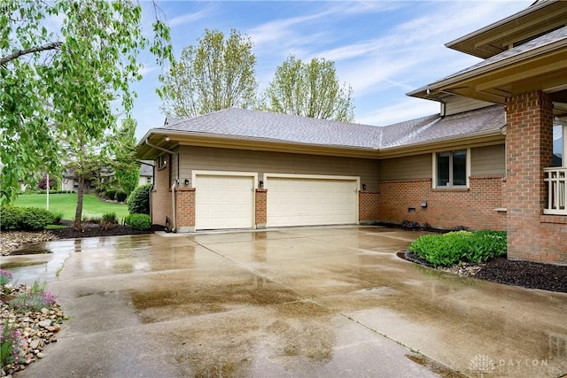 view of home's exterior with concrete driveway, an attached garage, and brick siding