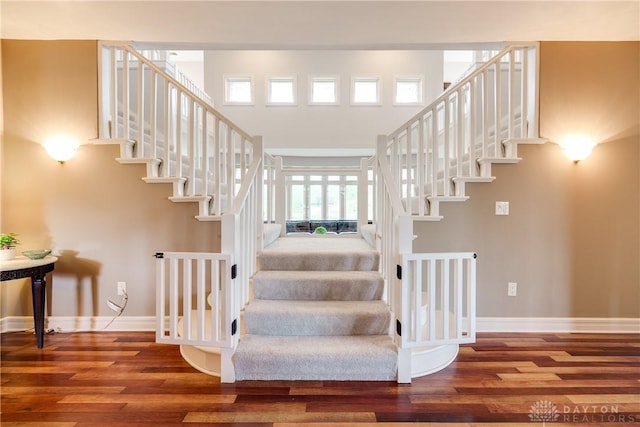 stairway with baseboards and wood finished floors