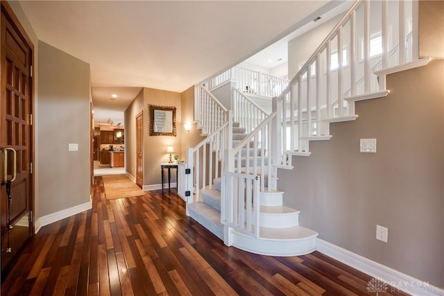 stairs featuring wood-type flooring and baseboards