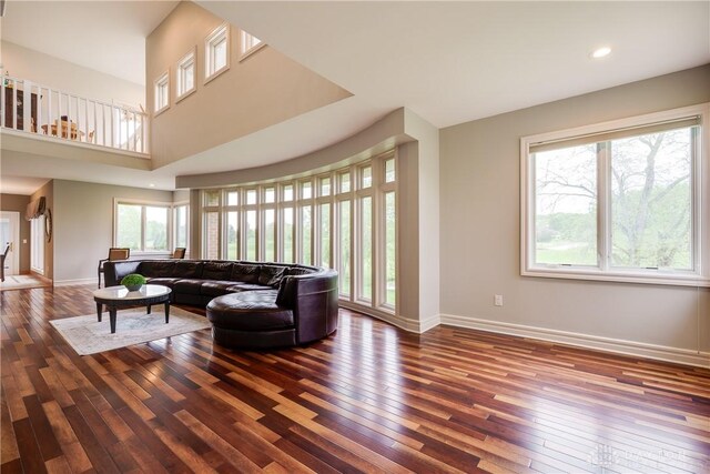living room featuring baseboards, recessed lighting, and hardwood / wood-style flooring