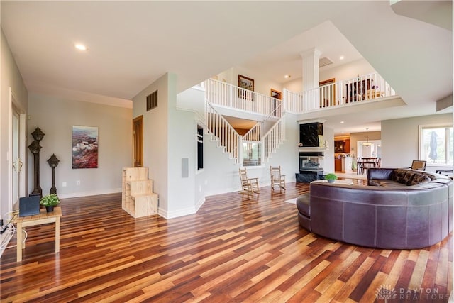 living room featuring recessed lighting, stairway, visible vents, and wood finished floors