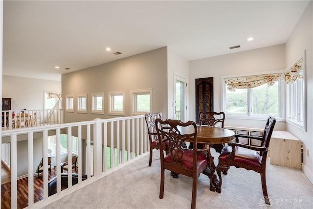 dining space with light colored carpet, visible vents, and recessed lighting
