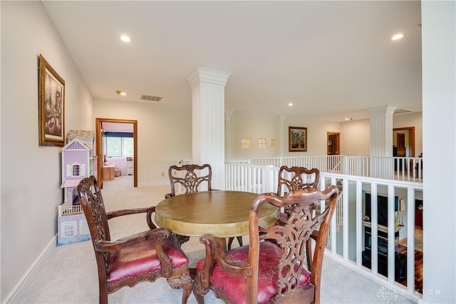carpeted dining space featuring baseboards, recessed lighting, visible vents, and ornate columns
