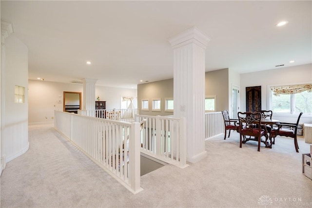hallway with decorative columns, an upstairs landing, recessed lighting, light carpet, and baseboards