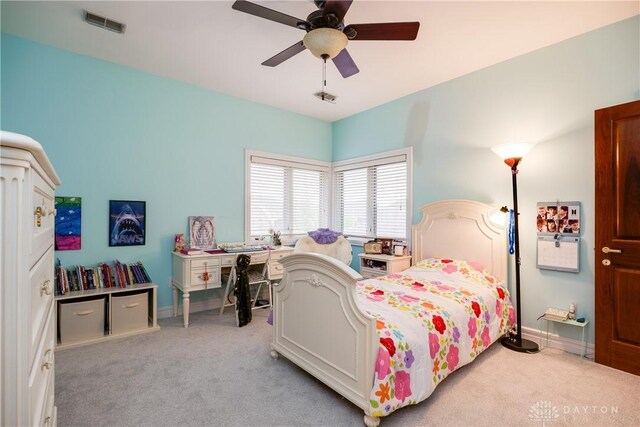 bedroom featuring light carpet, baseboards, visible vents, and ceiling fan