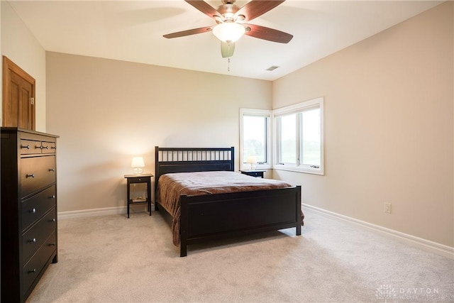 bedroom featuring baseboards, light carpet, visible vents, and a ceiling fan