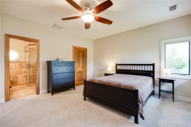 bedroom featuring connected bathroom, visible vents, baseboards, and light carpet