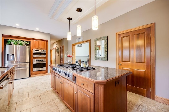 kitchen with decorative light fixtures, light tile patterned floors, a kitchen island, brown cabinets, and stainless steel appliances