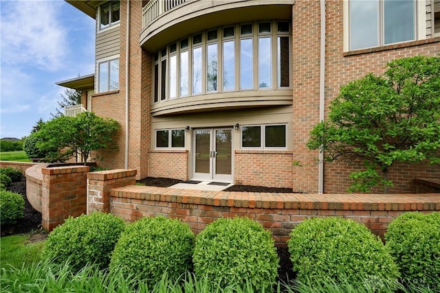 entrance to property with brick siding and french doors