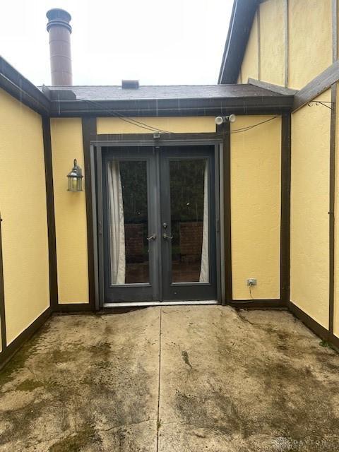entrance to property with stucco siding and french doors