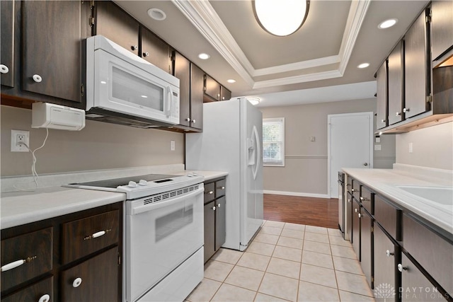 1824 Scotch Pine Dr, Beavercreek, OH 45432 - kitchen with a tray ceiling, dark brown cabinetry, recessed lighting, and white appliances