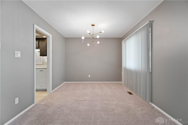 1824 Scotch Pine Dr, Beavercreek, OH 45432 - spare room with carpet, visible vents, baseboards, and an inviting chandelier
