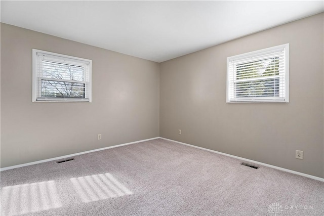 1824 Scotch Pine Dr, Beavercreek, OH 45432 - carpeted empty room with a wealth of natural light, baseboards, and visible vents