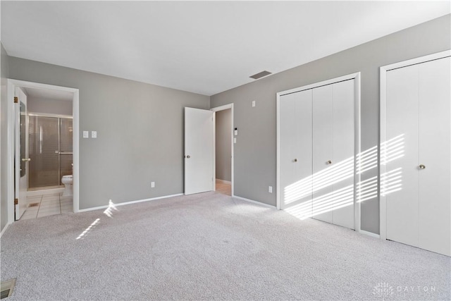 1824 Scotch Pine Dr, Beavercreek, OH 45432 - unfurnished bedroom with carpet flooring, multiple closets, visible vents, baseboards, and ensuite bath