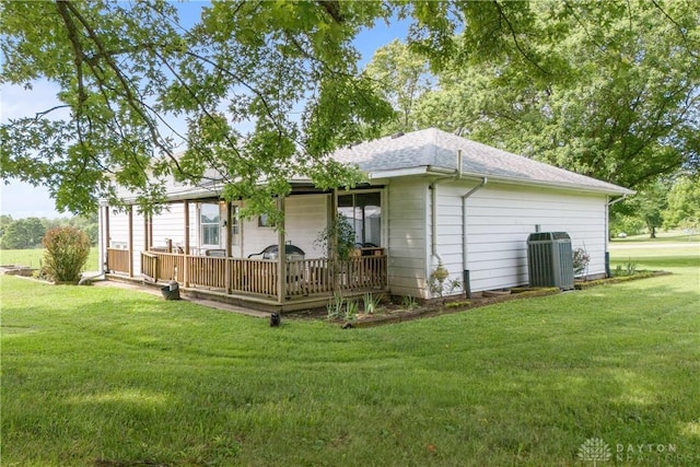 1572 State Route 380, Wilmington, OH 45177 - back of house featuring a yard, a wooden deck, a shingled roof, and central AC