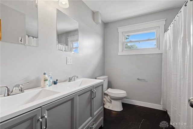 1572 State Route 380, Wilmington, OH 45177 - bathroom with double vanity, toilet, baseboards, and a sink