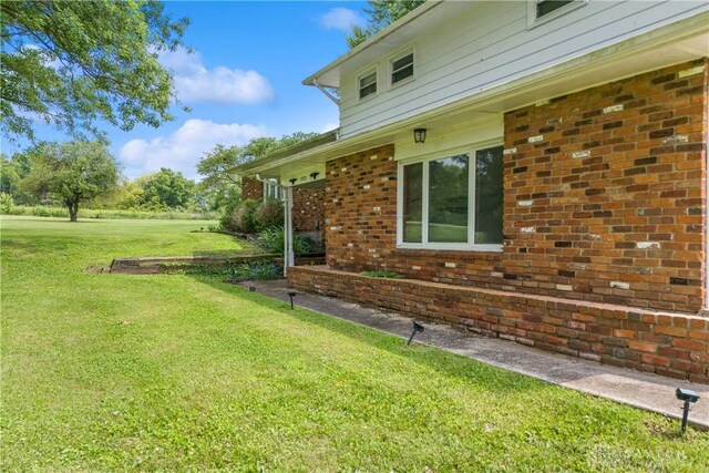 1572 State Route 380, Wilmington, OH 45177 - view of property exterior with a lawn and brick siding