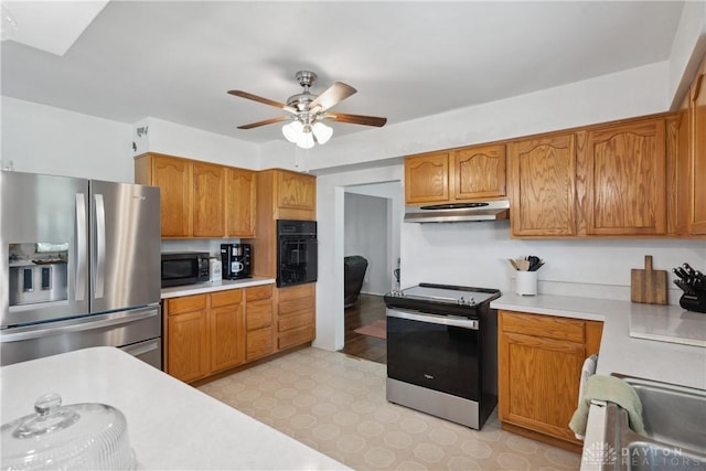 1572 State Route 380, Wilmington, OH 45177 - kitchen featuring a ceiling fan, light floors, black appliances, under cabinet range hood, and light countertops