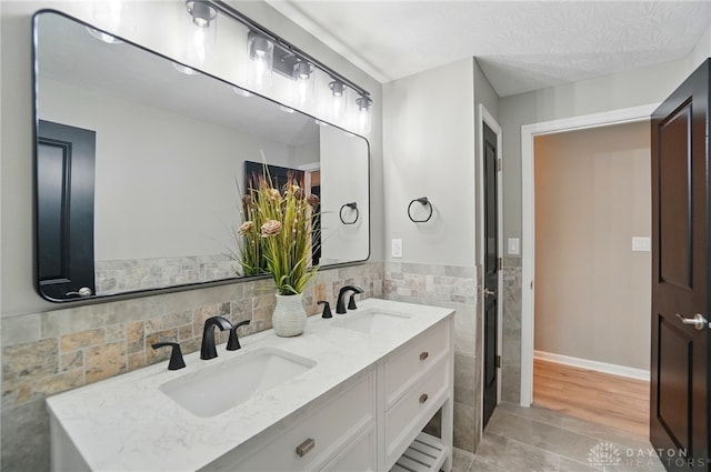 5741 Hithergreen Dr, Washington Twp, OH 45429 - bathroom featuring double vanity, tile walls, and tile patterned floors