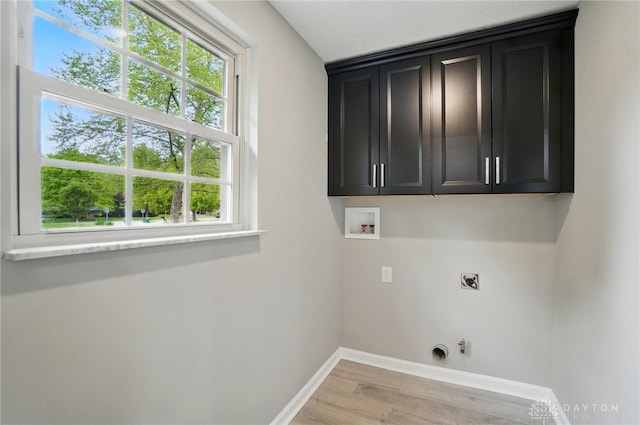 5741 Hithergreen Dr, Washington Twp, OH 45429 - washroom with hookup for an electric dryer, cabinet space, light wood-type flooring, washer hookup, and hookup for a gas dryer