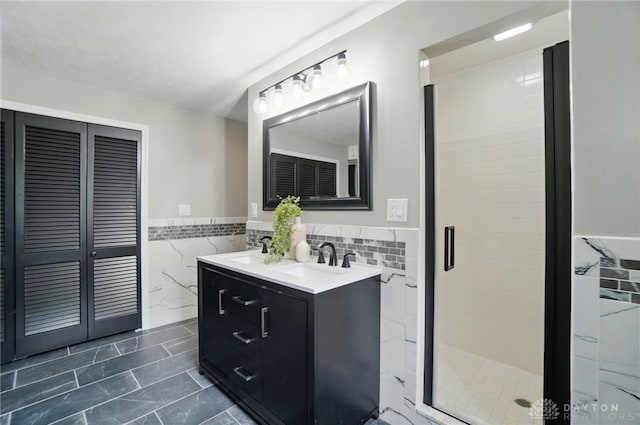 5741 Hithergreen Dr, Washington Twp, OH 45429 - bathroom with tile walls, double vanity, a wainscoted wall, a shower stall, and tile patterned flooring
